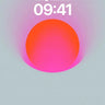 Phone lock-screen preview of a pink and orange orb surrounded by a hazy halo