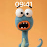 Playful Knit Creature Wallpaper with Wide-Eyed Surprise wallpaper for iPhone, iPad & Mac