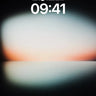 Phone lock-screen preview of a pale glowing horizon with an orange edge on black
