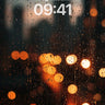 Rain-Streaked City Wallpaper with Warm Bokeh Lights wallpaper for iPhone, iPad & Mac